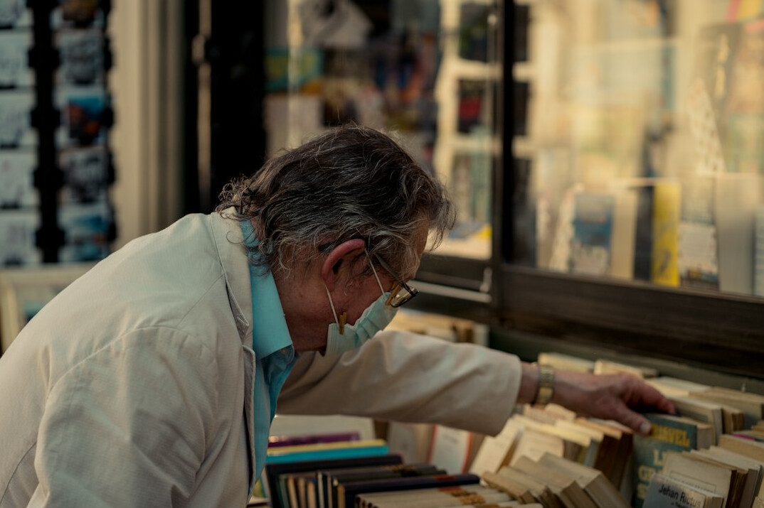 person browsing old books in shop